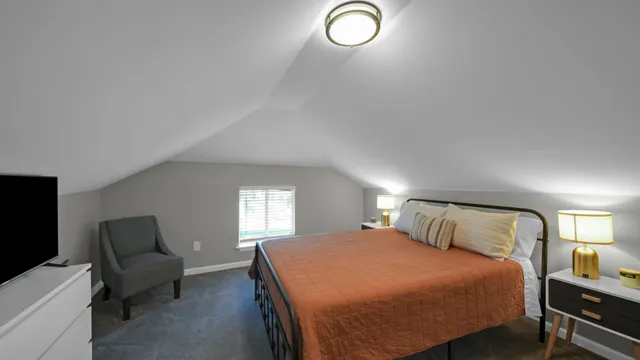 a bedroom with a bed and a mirror