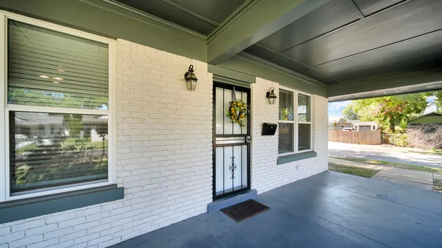 a view of a porch with wooden floor and a floor to ceiling window