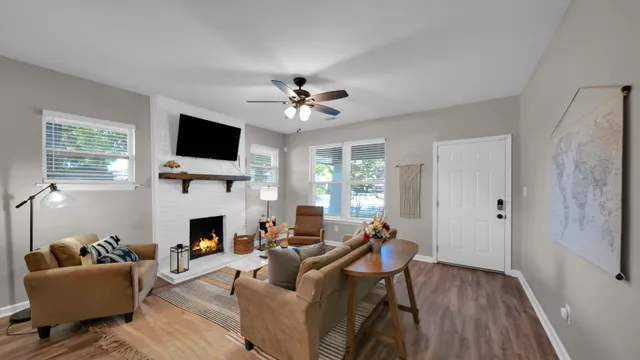 a living room with furniture a flat screen tv and a fireplace