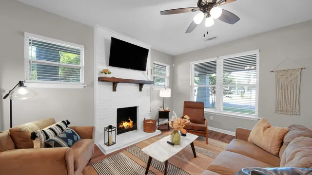 a living room with furniture a fireplace and a flat screen tv