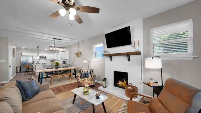 a living room with furniture a flat screen tv and a fireplace
