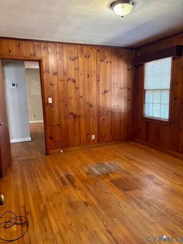 an empty room with wooden floor and closet