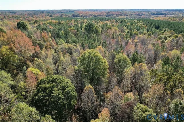 an aerial view of a houses with a yard