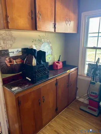 a kitchen with a sink window and cabinets