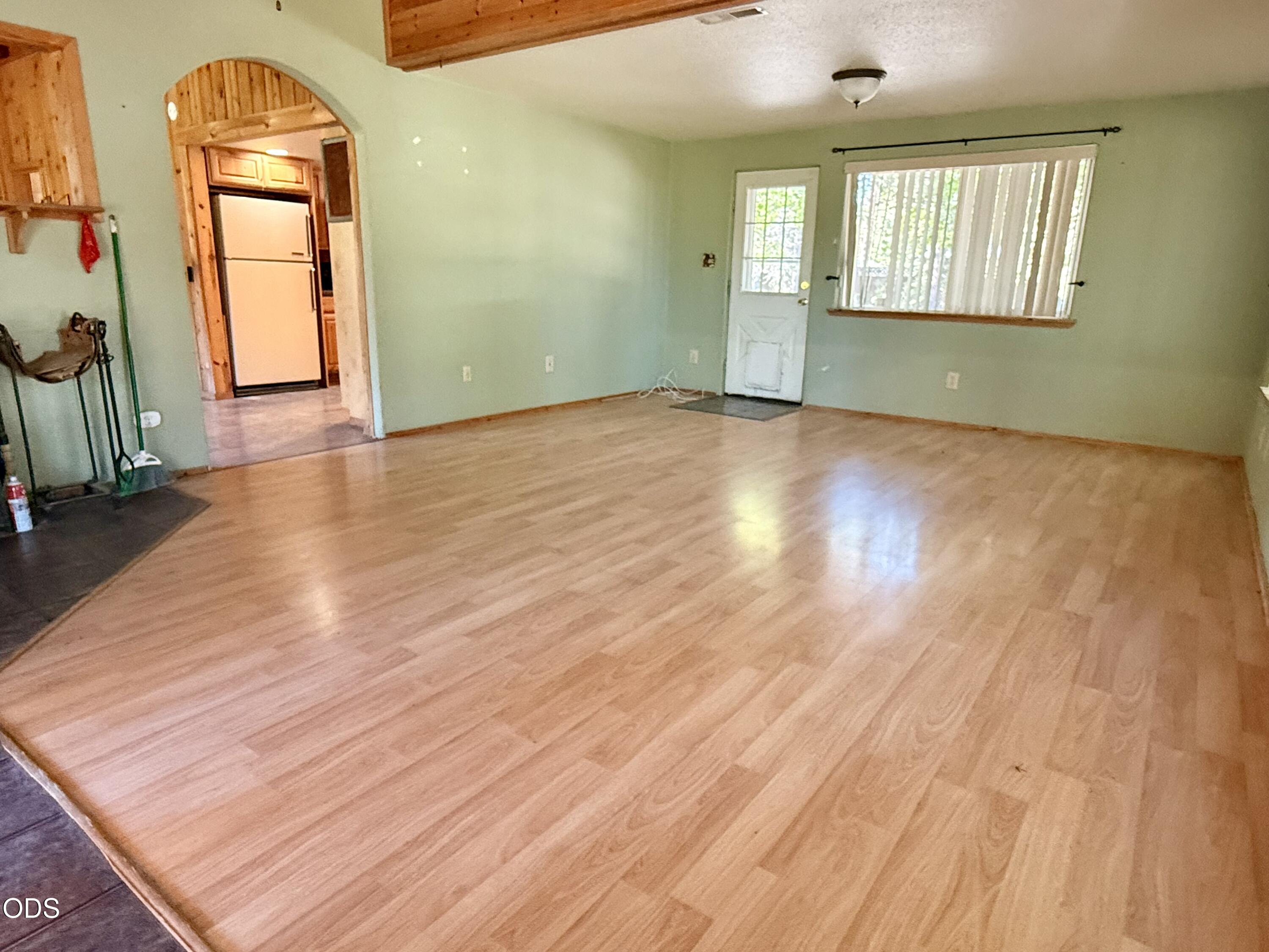 16025 Strawn Road La Pine, OR 97739 - Photo 10 of 95 an empty room with wooden floor and windows