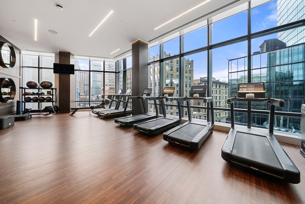 40 Trinity Place, Unit 1518 Boston, MA 02116 - Photo 23 of 25 a room with gym equipment and a large window