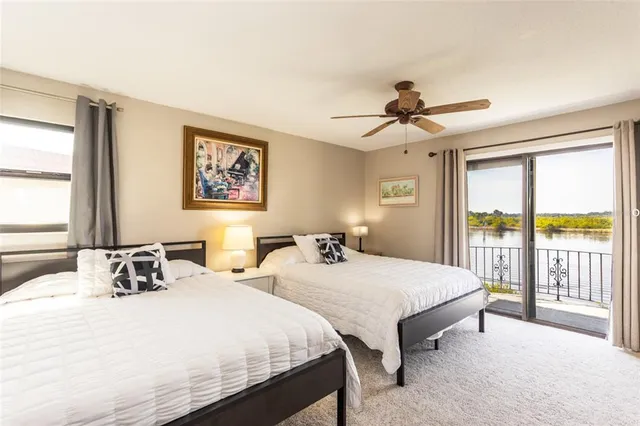 a bedroom with two beds and a large window