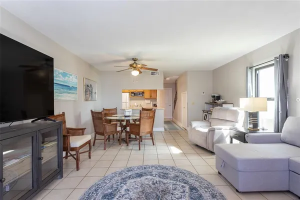 a living room with furniture a rug and a flat screen tv