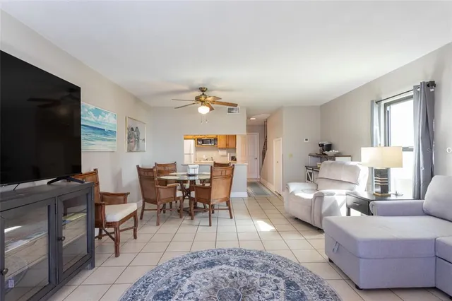 a living room with furniture a rug and a flat screen tv