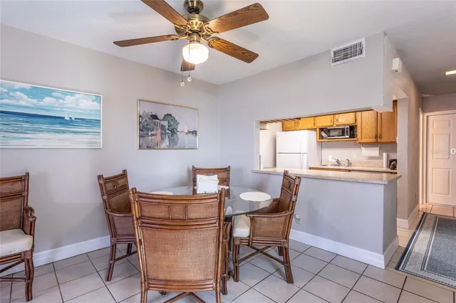 a dining room with a large window table and chairs