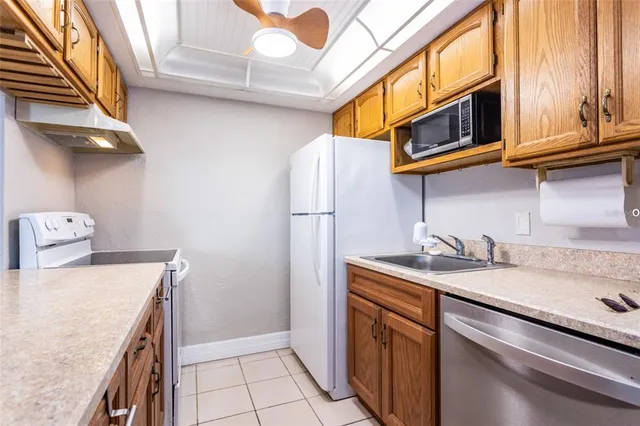 a kitchen with stainless steel appliances granite countertop a sink and a stove