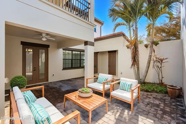 a backyard of a house with table and chairs