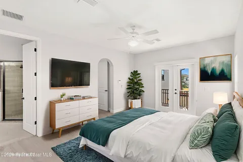 a bedroom with a flat screen television and a bed