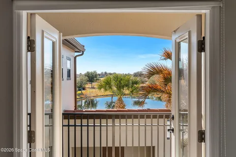 a view of a balcony with lake view and floor to ceiling window