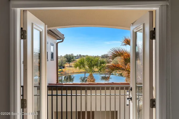 a view of a balcony with lake view and floor to ceiling window