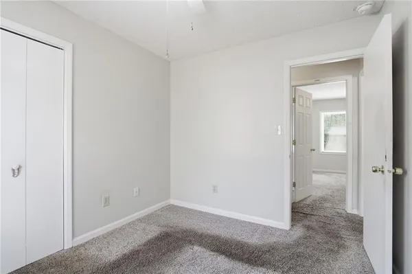 an empty room that has a glass door and shower