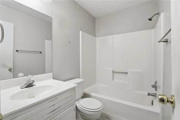 a bathroom with a sink a toilet and a bathtub