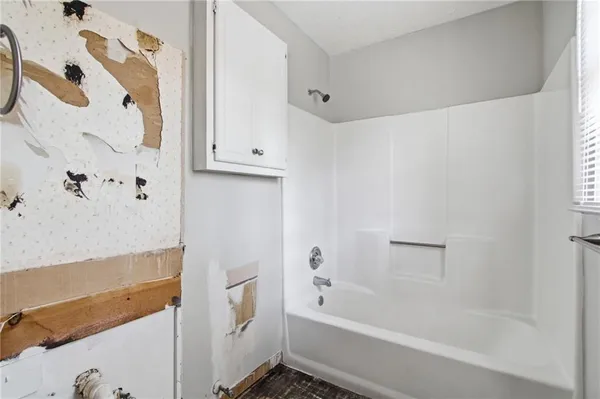 a bathroom with a bathtub and shower
