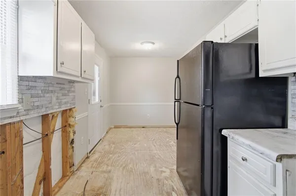 a kitchen with stainless steel appliances granite countertop a refrigerator and a sink