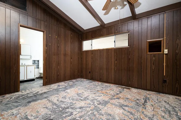 a view of a big room with wooden floor closet and windows