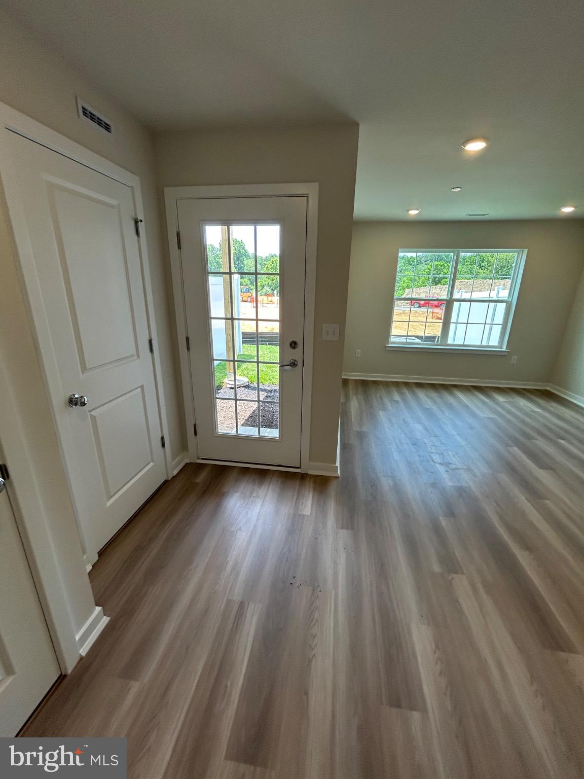 74 Morgans Ml Road Sicklerville, NJ 08081 - Photo 4 of 39 an empty room with wooden floor and windows