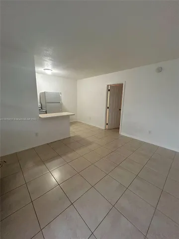 a view of a refrigerator and window in a room