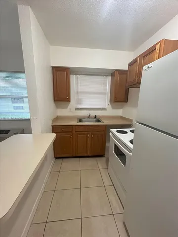 a kitchen with a cabinets and white appliances