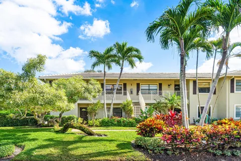 a view of a palm trees in front of a house