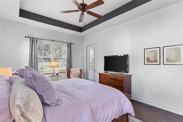 a bedroom with bed and a large window