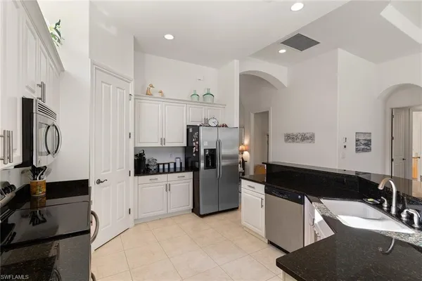a view of a chairs and table in patio with a yard