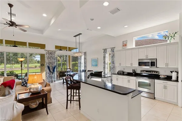 a kitchen with stainless steel appliances kitchen island granite countertop a sink and cabinets
