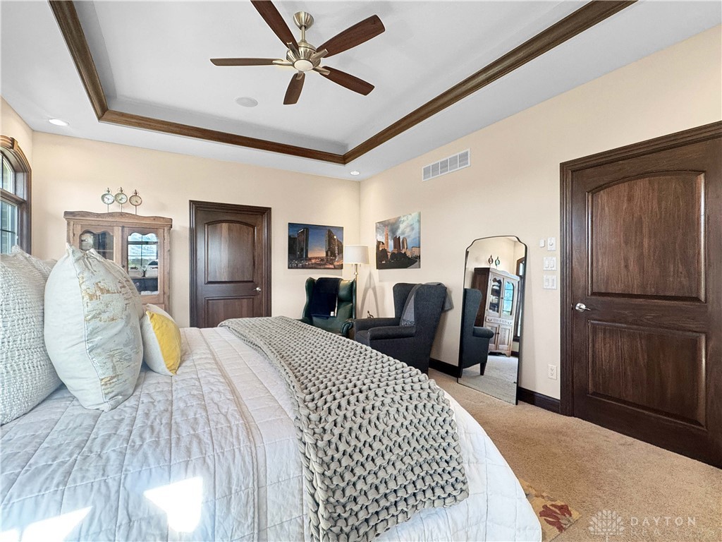 4096 Middle Urbana Road Urbana, OH 43078 - Photo 90 of 96 This spacious bedroom features elegant tray ceilings and plush carpet flooring.