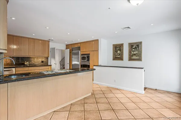 a kitchen with stainless steel appliances a stove a sink and a refrigerator