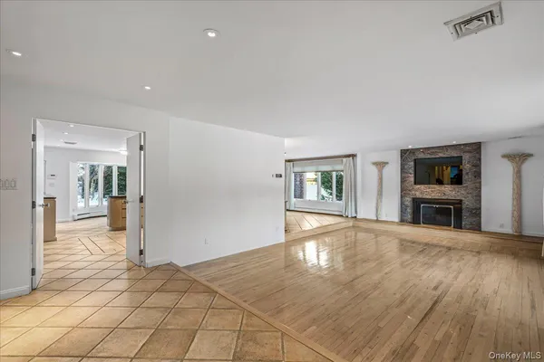 a view of a livingroom with wooden floor and furniture