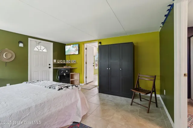 a bedroom with a bed and a chair