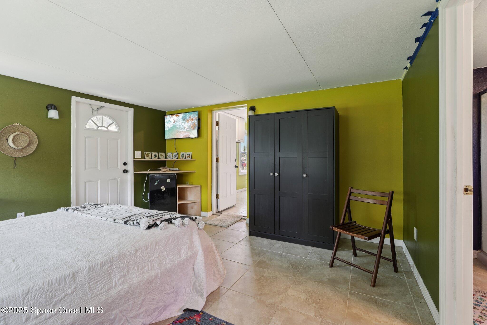 72 Rockledge Avenue Rockledge, FL 32955 - Photo 15 of 28 a bedroom with a bed and a chair