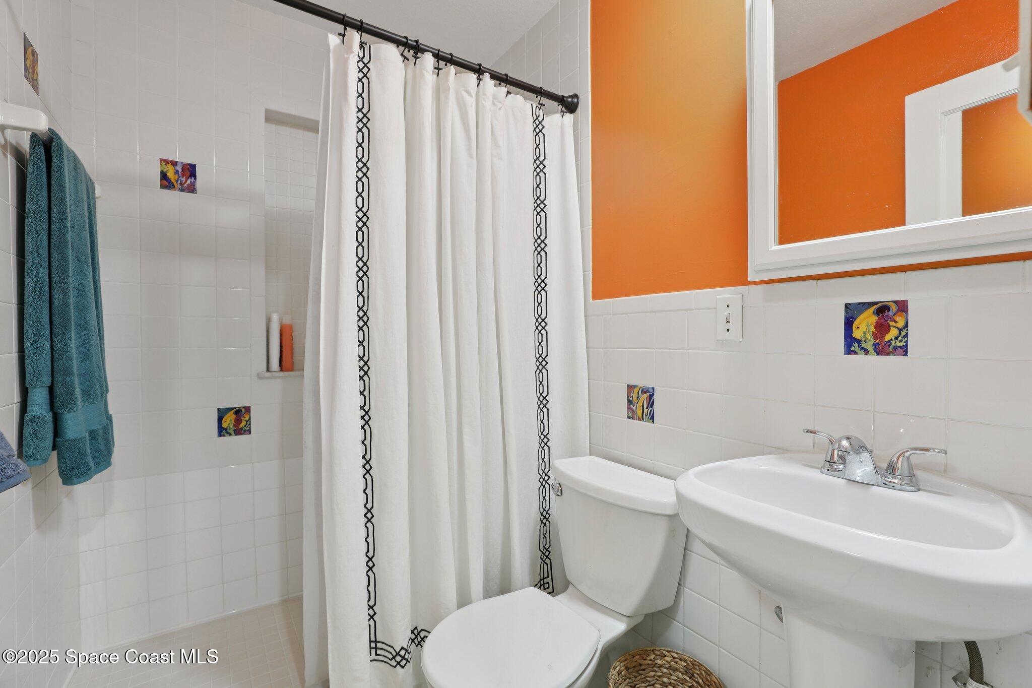 72 Rockledge Avenue Rockledge, FL 32955 - Photo 19 of 28 a bathroom with a sink toilet and shower