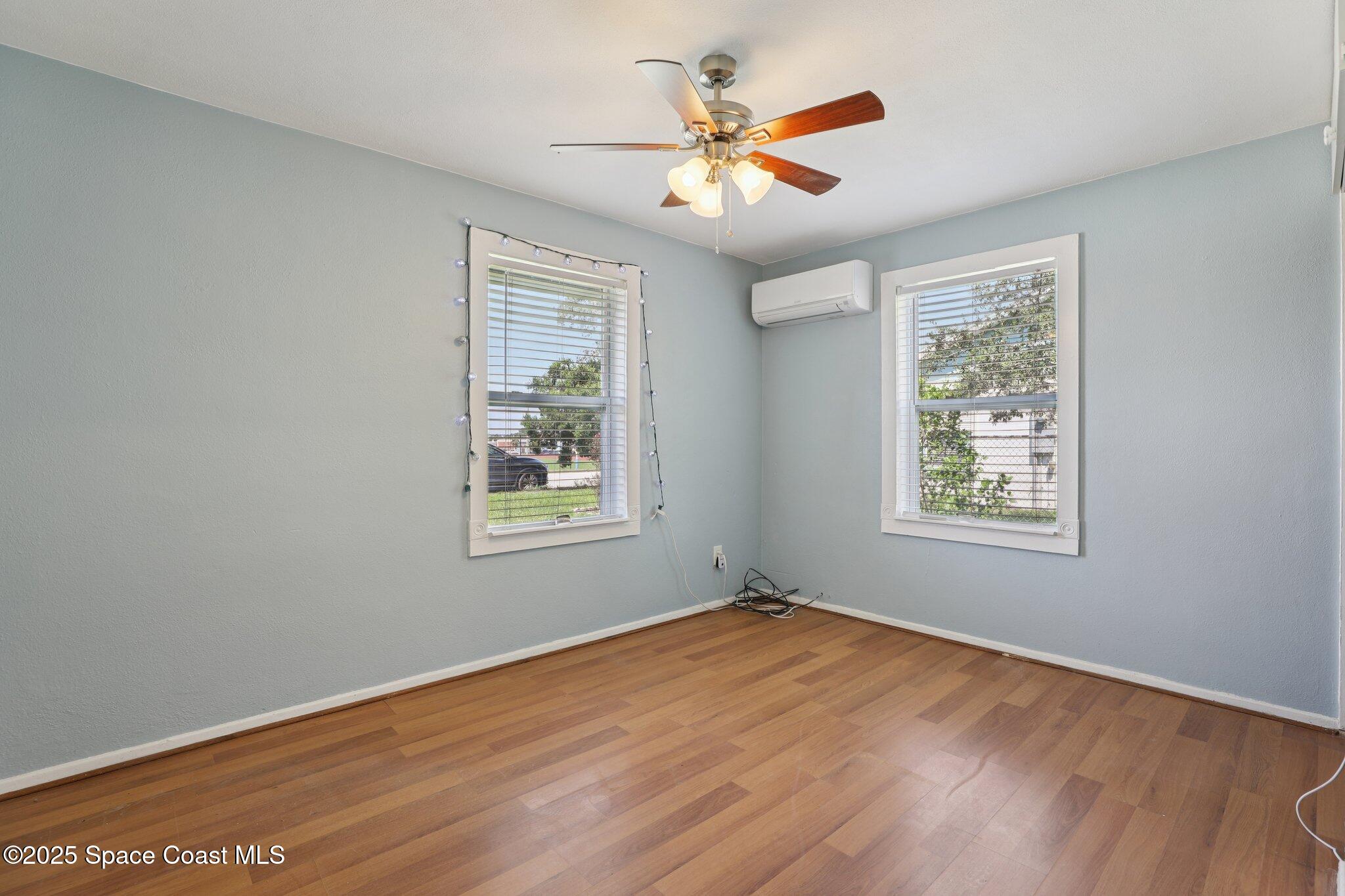 72 Rockledge Avenue Rockledge, FL 32955 - Photo 20 of 28 a view of an empty room with wooden floor and a window
