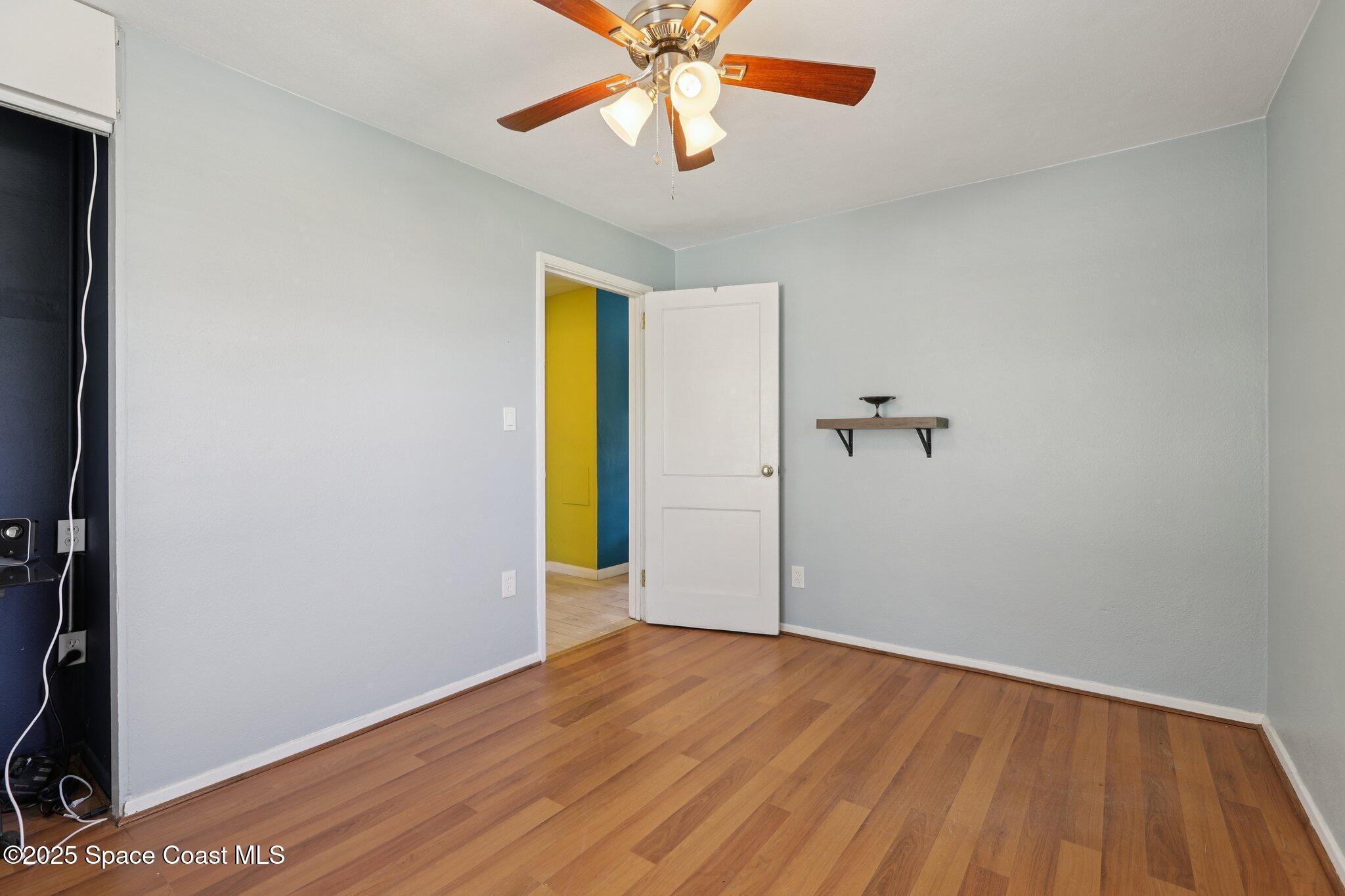 72 Rockledge Avenue Rockledge, FL 32955 - Photo 21 of 28 a view of empty room with a window and wooden floor