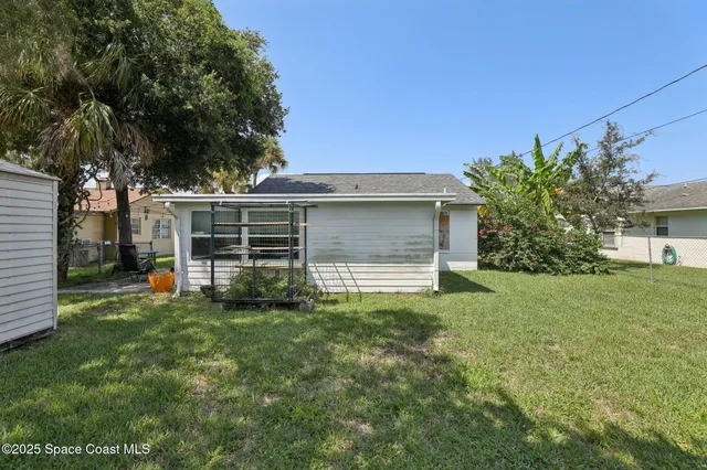 a view of a house with yard and a garden