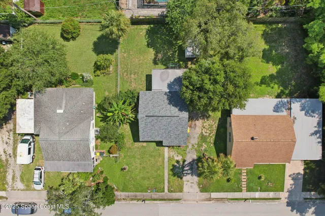 an aerial view of a house with outdoor space and street view