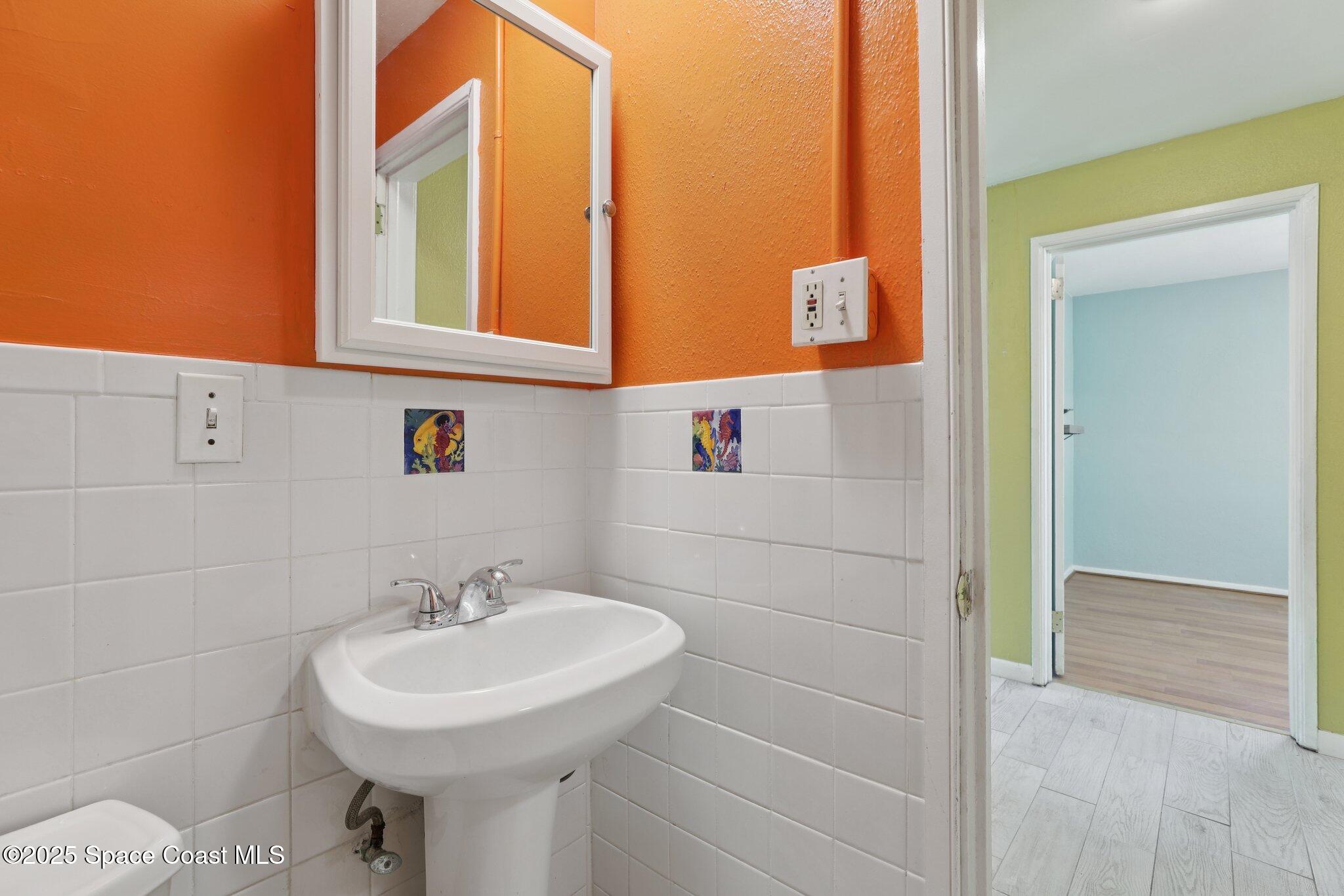 72 Rockledge Avenue Rockledge, FL 32955 - Photo 7 of 28 a bathroom with a sink and a mirror