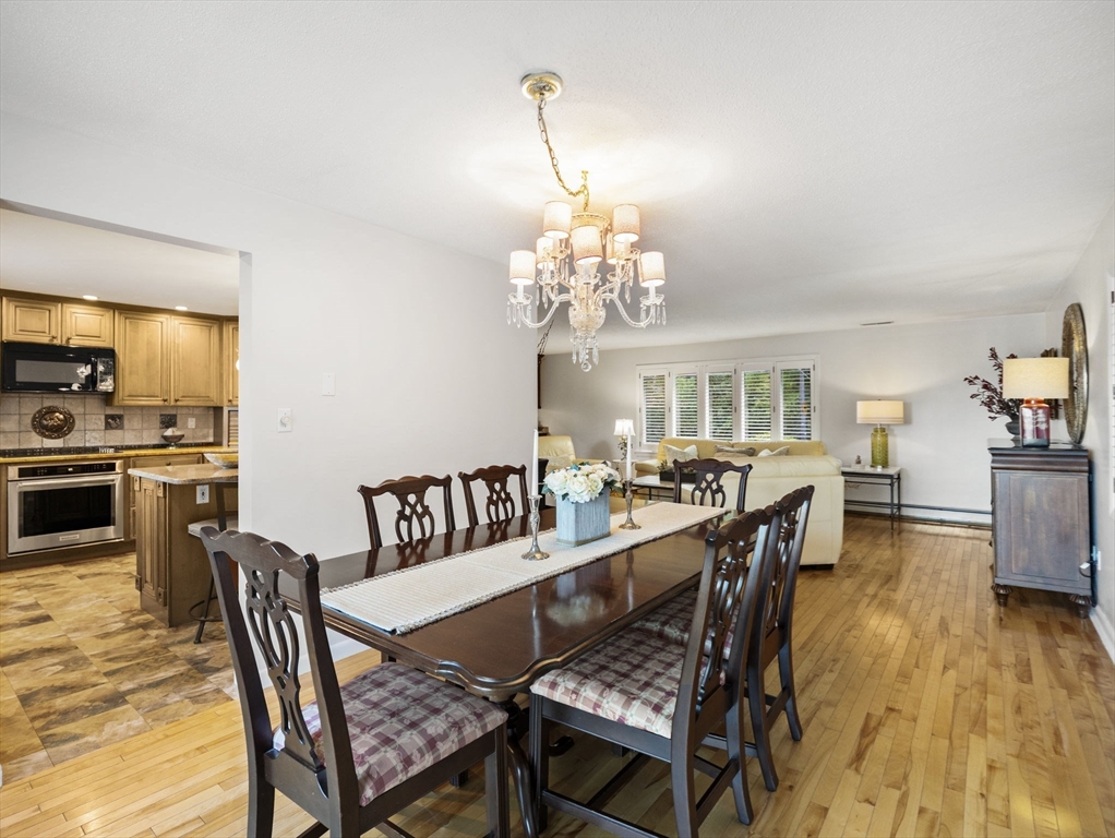 15 North Street Andover, MA 01810 - Photo 15 of 42 a dining room with furniture a chandelier and wooden floor