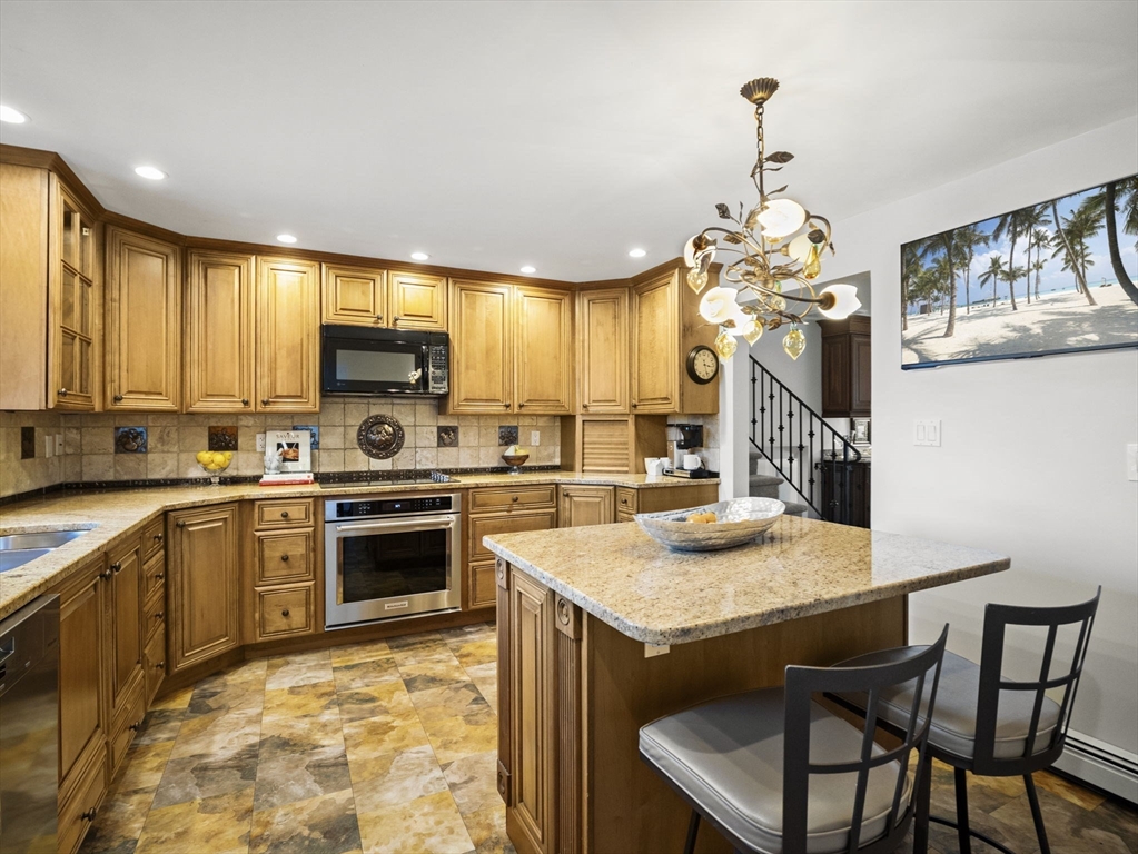 15 North Street Andover, MA 01810 - Photo 16 of 42 a kitchen with a table chairs stove and refrigerator