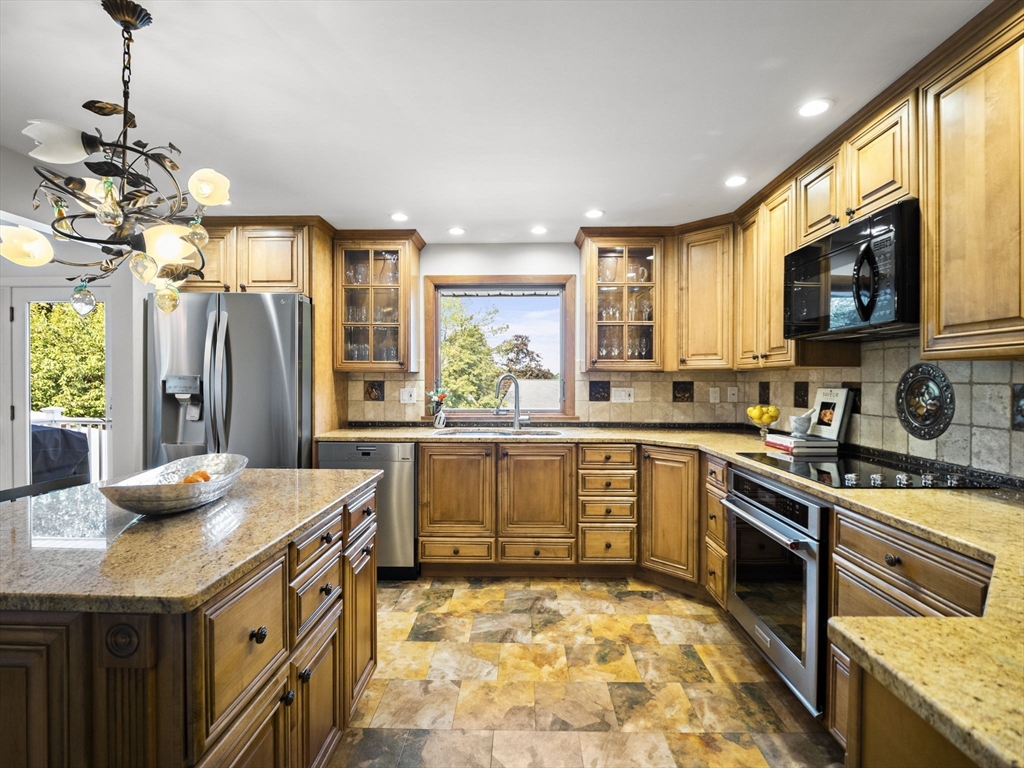 15 North Street Andover, MA 01810 - Photo 18 of 42 a kitchen with stainless steel appliances granite countertop a sink stove and refrigerator