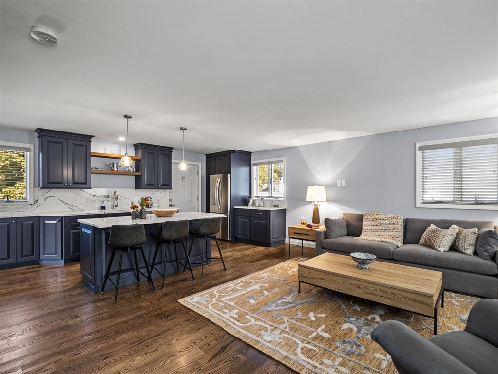 15 North Street Andover, MA 01810 - Photo 34 of 42 a living room with furniture a wooden floor and kitchen view