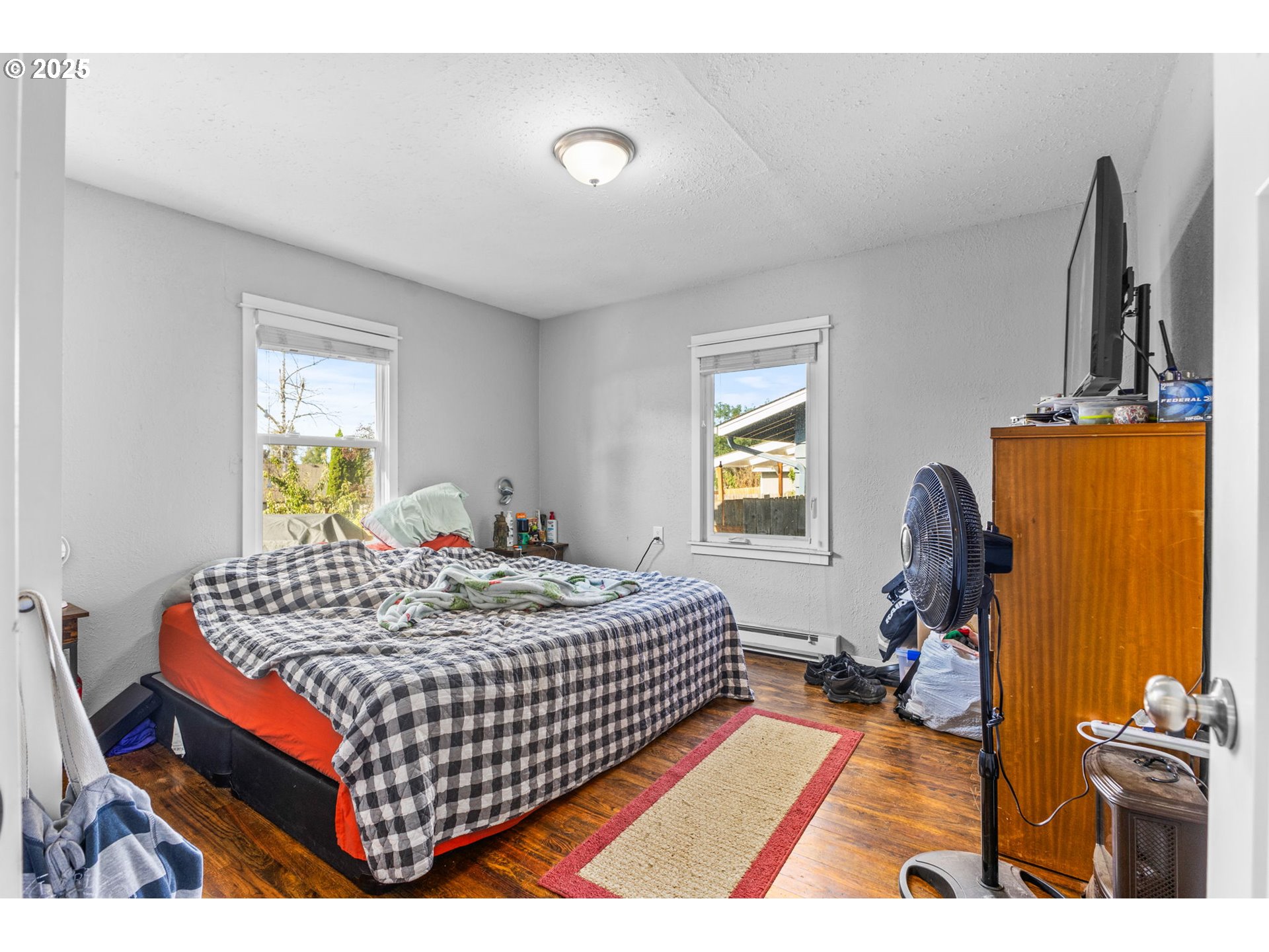 221 Southwest Rainbow Avenue Dallas, OR 97338 - Photo 16 of 36 a bedroom with a bed and wooden floor