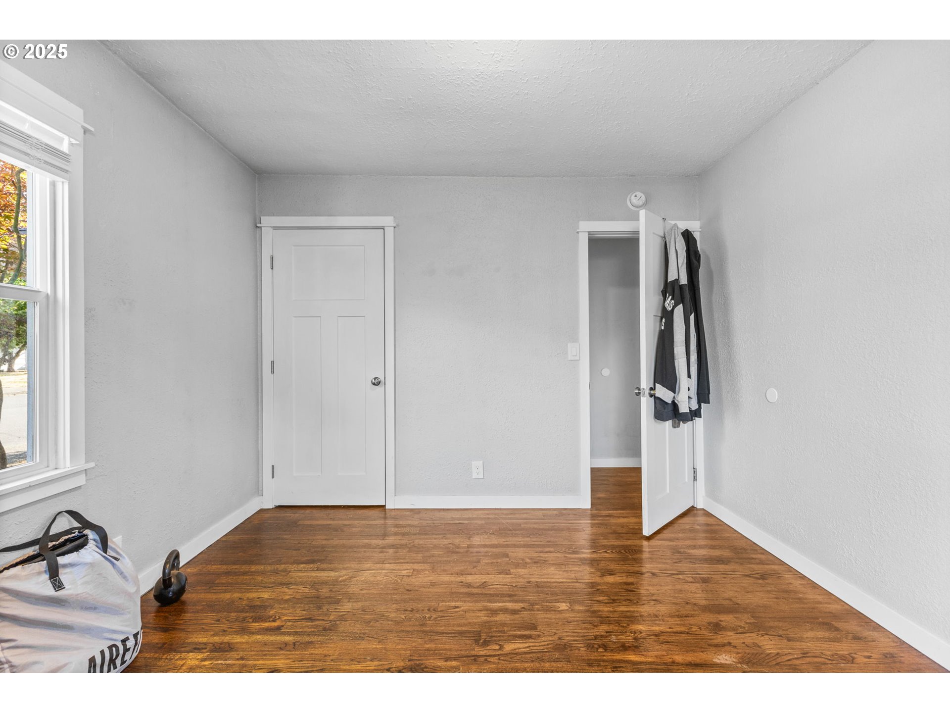 221 Southwest Rainbow Avenue Dallas, OR 97338 - Photo 19 of 36 a view of empty room with wooden floor and fan