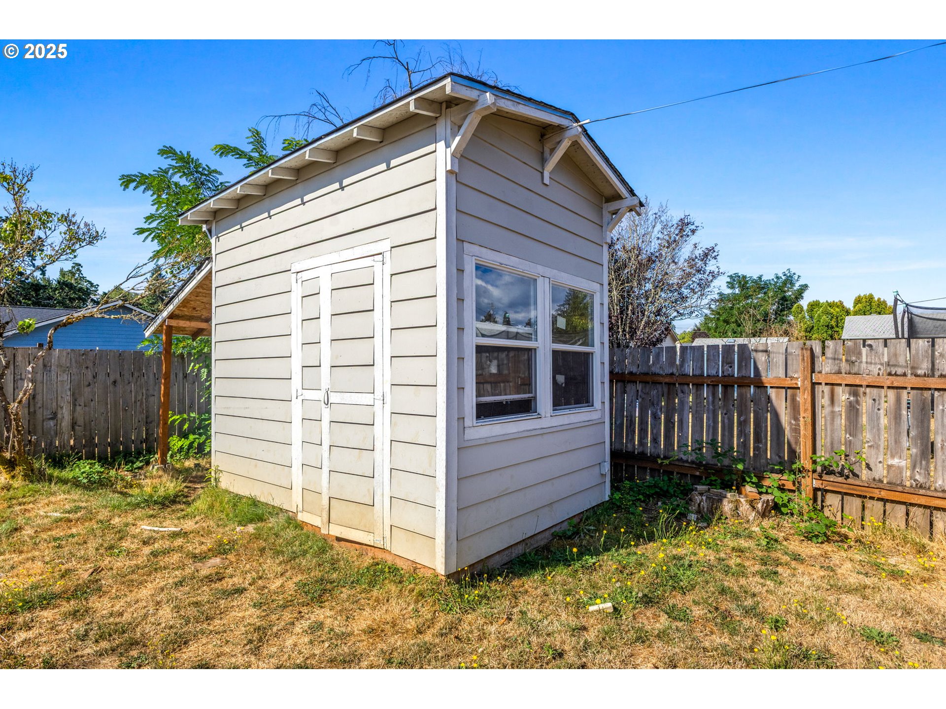 221 Southwest Rainbow Avenue Dallas, OR 97338 - Photo 31 of 36 a view of backyard with small cabin and wooden fence