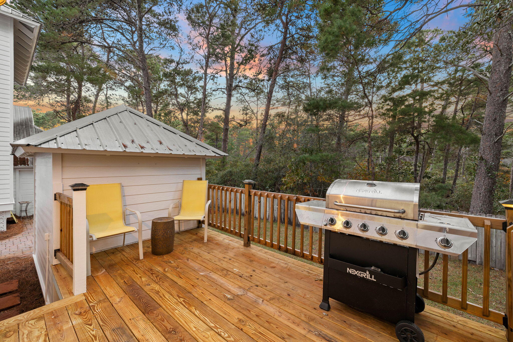 482 Hidden Lake Way Santa Rosa Beach, FL 32459 - Photo 20 of 51 a view of a deck with table and chairs a barbeque with wooden floor and fence